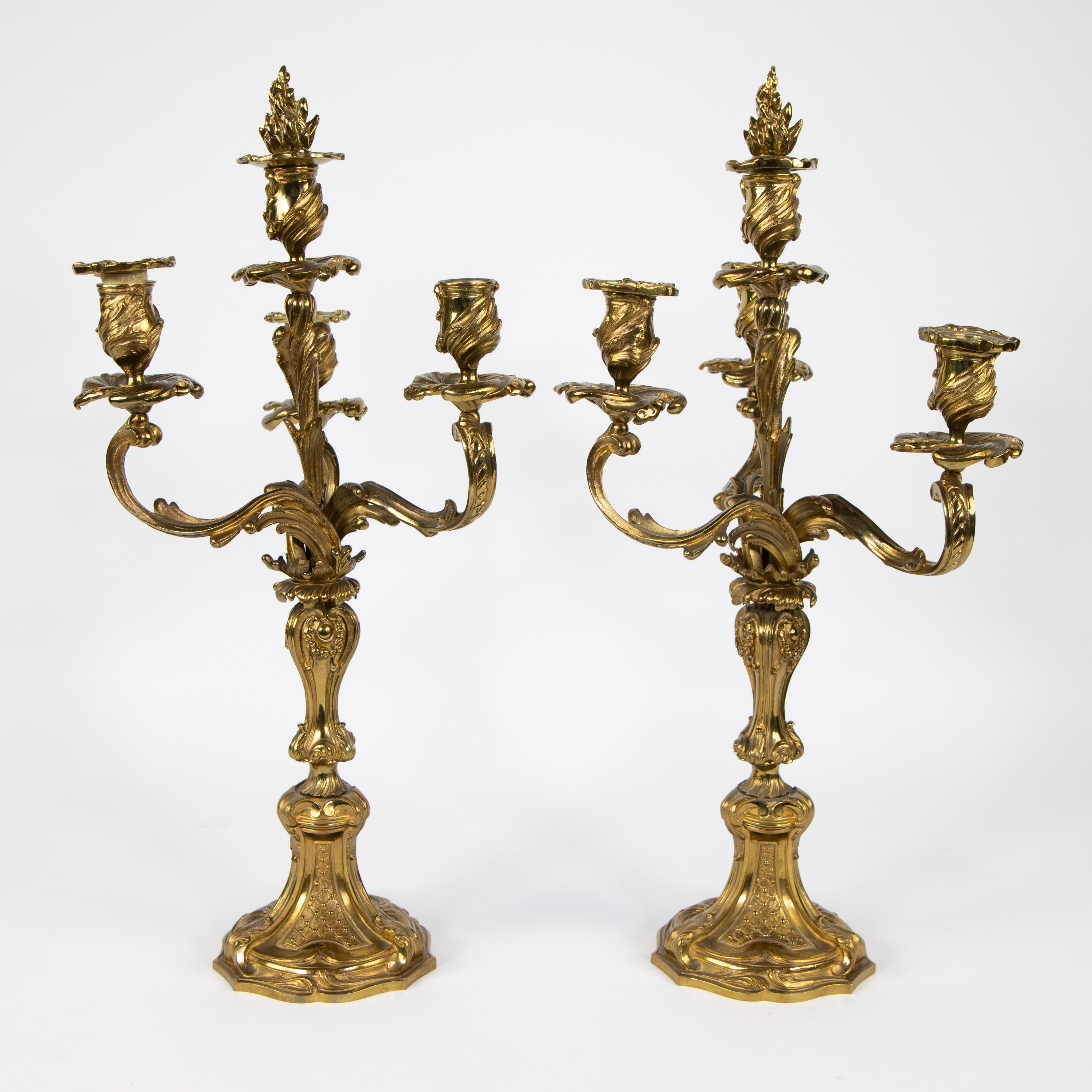 A pair of French gilt bronze Louis XV style four-light candlesticks, 19th/20th C.