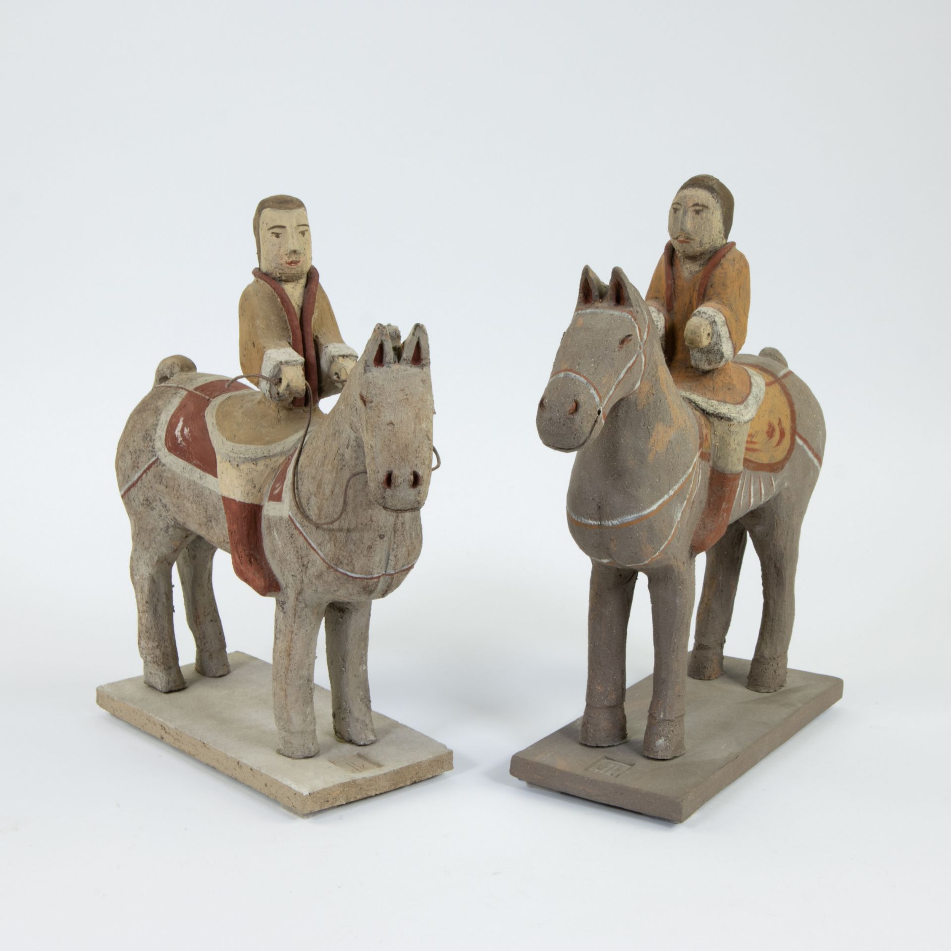 Collection of 2 terracotta horses with rider, contemporary, marked DK