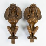 2 large wooden ornaments of griffins
