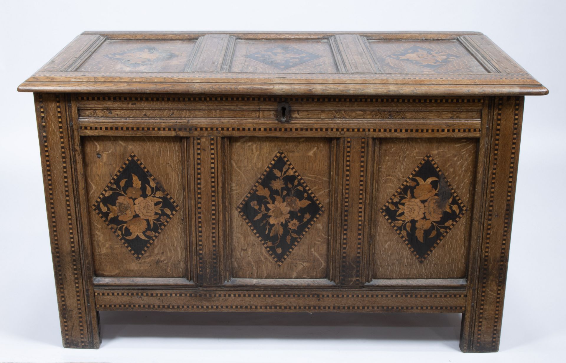 18th-century oak blanket chest with floral inlay and geometric block pattern