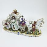 A royal horse-drawn carriage of hand-painted polychrome porcelain, with gilded crown and elegant fig