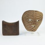 African mask and a neck rest