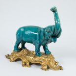 L. Rocher, a ceramic statue of an elephant, mounted on a bronze gilded base, marked