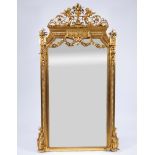 Large richly decorated gilt wall mirror decorated with garlands of flowers and putti, Louis XVI styl
