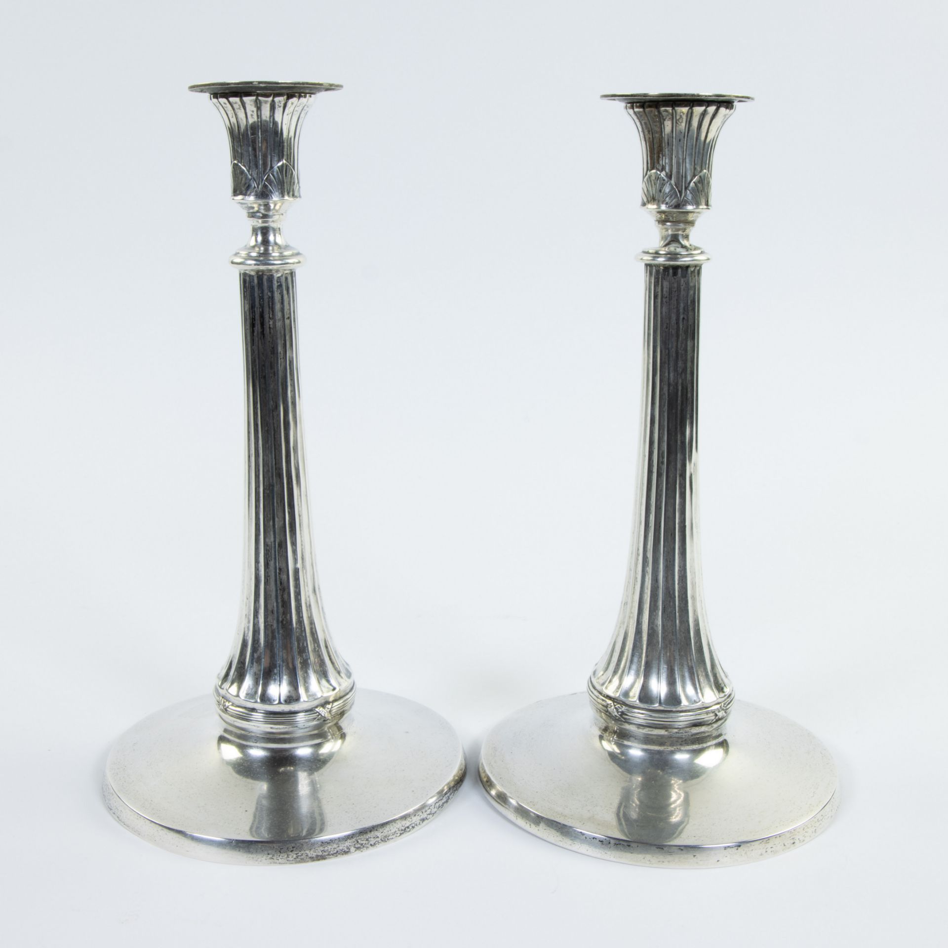 Pair of silver candlesticks, round model with contoured column with fluting, marked 800