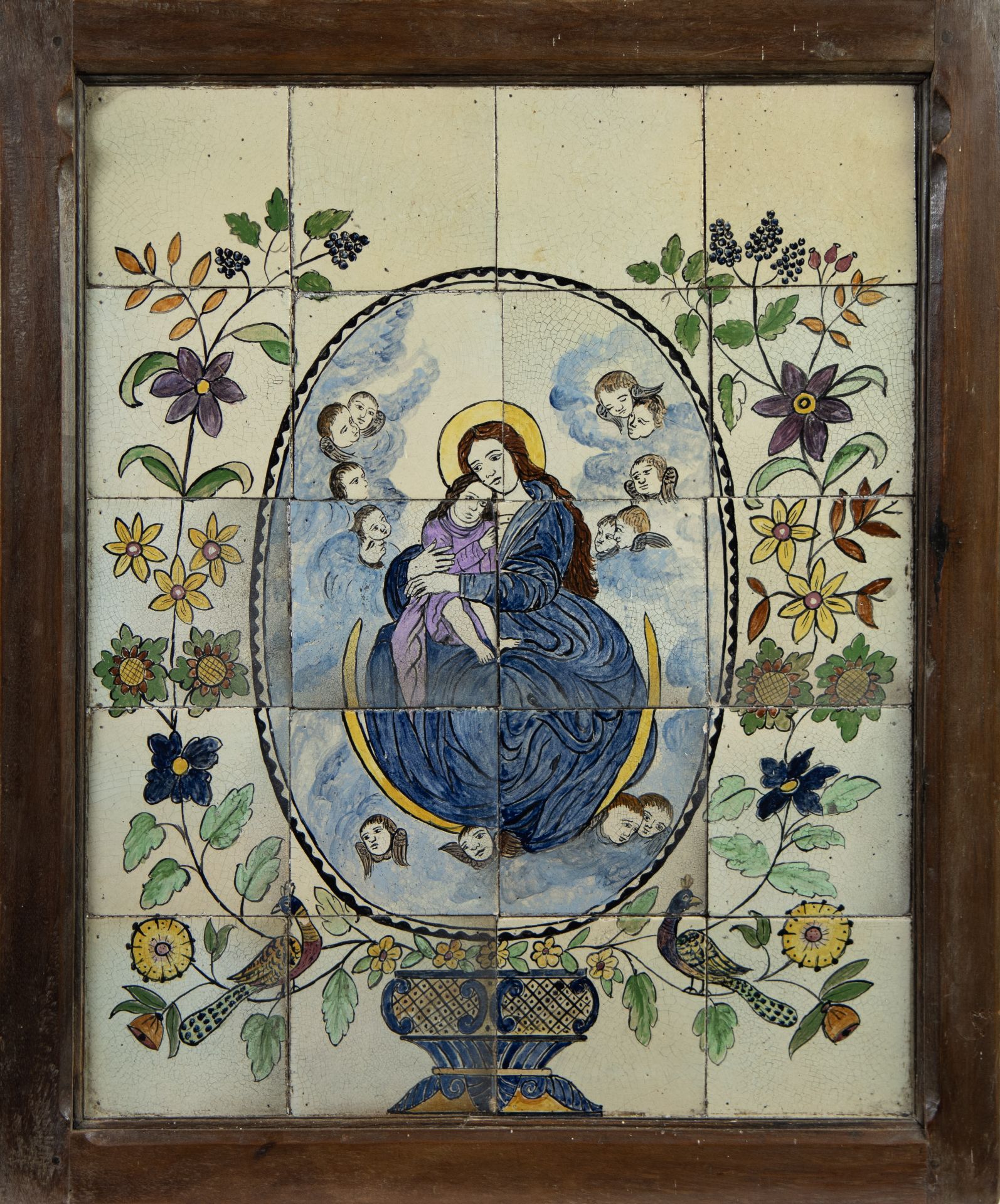 Tiled tableau with Madonna and child in medallion surrounded by childheads and floral motifs, 18/19t