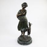 Bronze sculpture of a girl with buck, signed.