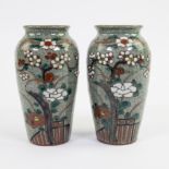 Pair of Japanese enamel vases with floral decor on green crackle background