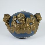Decorative ball element with blue fond surrounded by gilt relief of putti