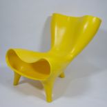 The yellow Orgone Chair by Marc Newson, plastic, marked