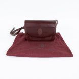 Red leather shoulder bag from Cartier with matching fabric storage bag