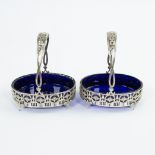 2 solid silver salt baskets beautifully ornamented in Louis XVI style with blue glasses