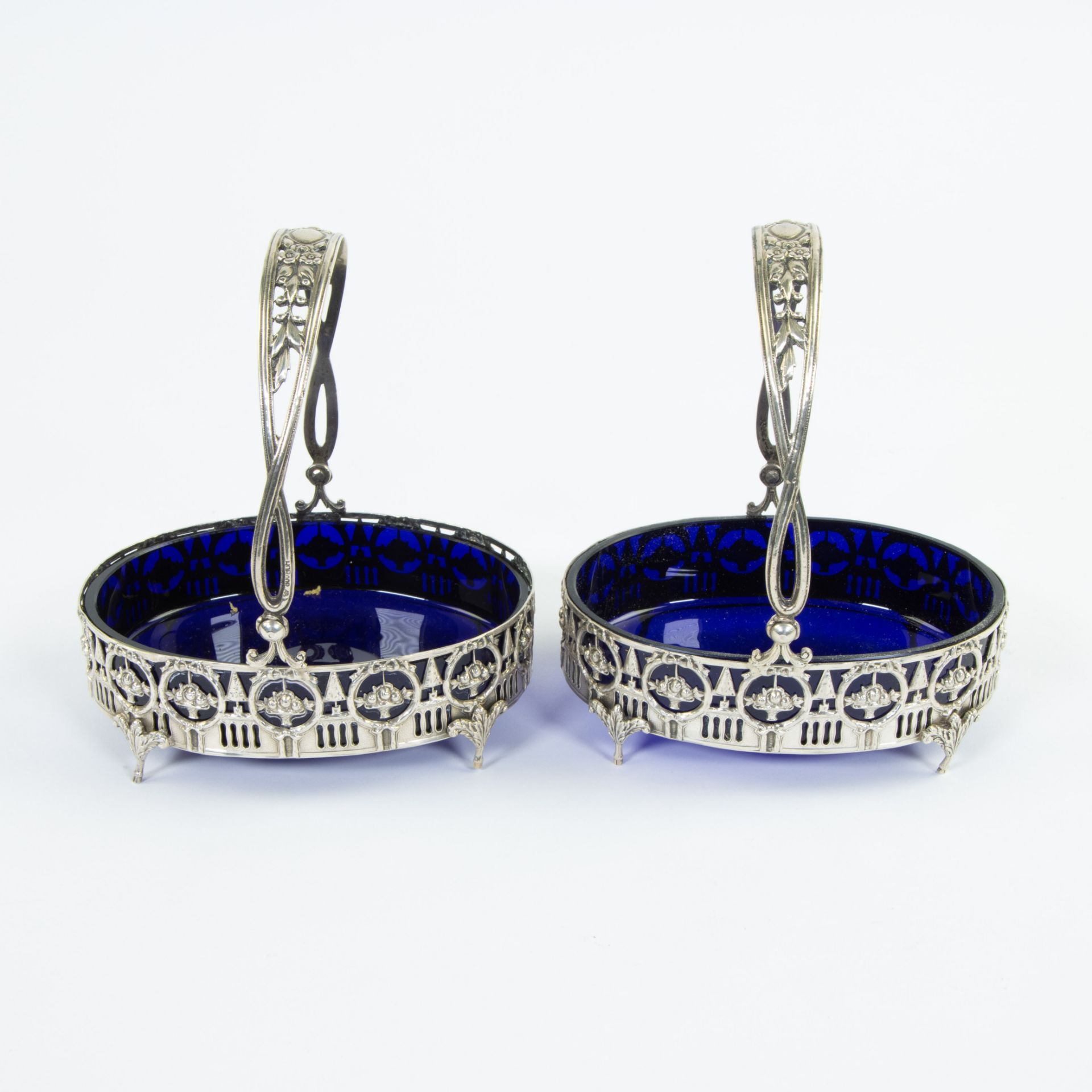 2 solid silver salt baskets beautifully ornamented in Louis XVI style with blue glasses