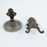 An Art Deco match lighter and a cast iron boot cutter 19th century