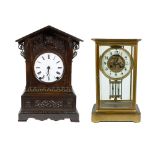 2 clocks, a glass pendulum with compensating pendulum in gilt brass case and a wooden clock, Black F