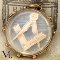 An Antique Masonic Charm The 9ct rose gold charm has masonic set squares inside a glass locket.