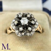 An Antique Rose Diamond Cluster Ring The ring is set with a 0.20ct old cut diamond to the centre