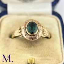 An Antique Green Tourmaline Ring The gold ring is set with an oval green tourmaline and the band and