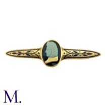 A Carved Opal and Enamel Brooch The unusual antique gold brooch is set with an impressive carved
