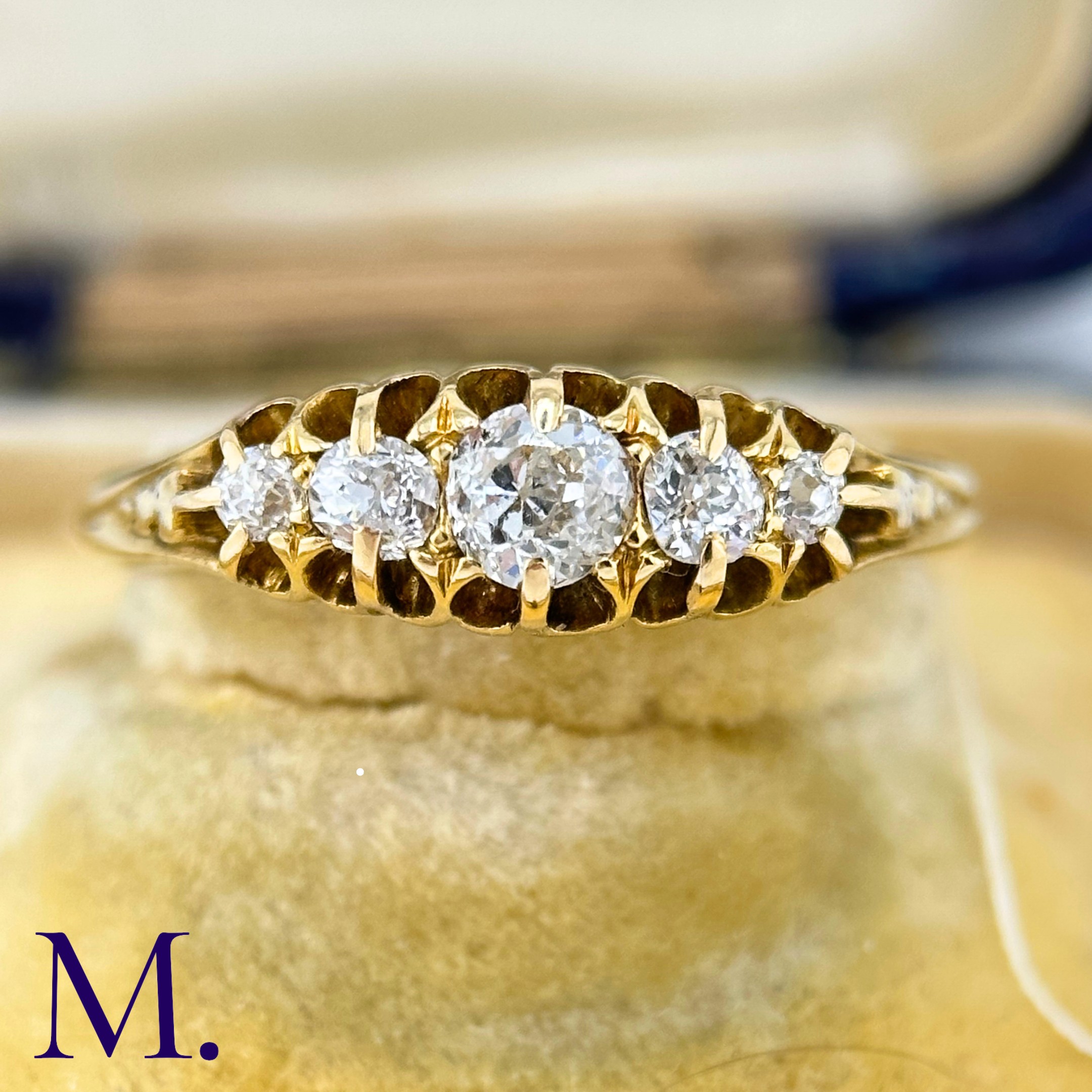 An Antique 5-Stone Diamond Ring The 18ct yellow gold band is set with five bright old cut