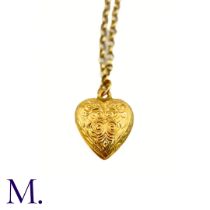 An Antique Heart Charm and Chain The 9ct gold chain suspends an engraved heart pendant. Weight: 3.7g