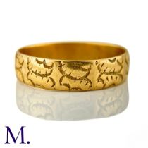 A Carved 18ct Gold Band The 18ct yellow gold band is engraved with recurrent patterns. Weight: 4.