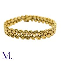 A Gold Bracelet by Boucheron The 18ct yellow gold bracelet with foliate form is by Boucheron Paris