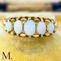 An Antique 5-Stone Opal Ring The 18ct yellow gold ring is set with five oval opals of good colour.