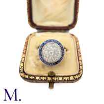 A Sapphire and Diamond Target Ring The 18ct yellow gold ring is set with a round fascia of bright