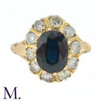 A Sapphire and Diamond Cluster Ring The 18ct yellow gold ring is set with a 1.6ct oval cut