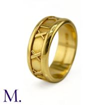 An 18ct Gold Atlas Band by Tiffany & Co. The 18ct yellow gold band with Roman numerals in surround