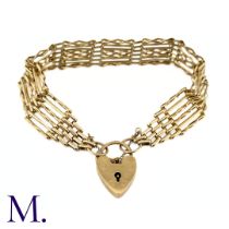 A Vintage Gold Gate Bracelet The 9ct yellow gold gate bracelet is secured with a heart-shaped