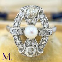 An Art Deco Pearl and Diamond Ring The 18ct white gold openwork ring is set with a pearl to the