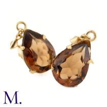 A Pair of Gemstone Earrings The 9ct yellow gold earrings are set with a burnt orange-brown pear-