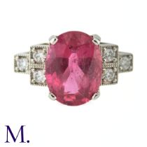 A Ruby and Diamond Ring The 18ct white gold ring is set with a bright pink ruby of approximately 3.