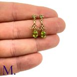 A Pair of Antique Peridot Earrings The peridot earrings are set in 9ct yellow gold. The earrings are