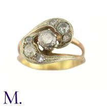 A Diamond Twist Ring The yellow gold ring is set with a 0.35ct old cut diamond to the centre with