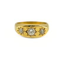 A Diamond Gypsy Ring. The 18ct yellow gold gypsy ring is set with three round cut diamonds