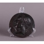 A patinated bronze relief tondo with portrait of Gioachino Rossini with laurel wreath, (1864)