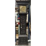 A black, richly carved English grandfather clock with melody on eight bells. Circa 1760.