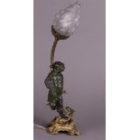 A French brass lamp base with a bronze figurine of a street boy on top. about 1880..