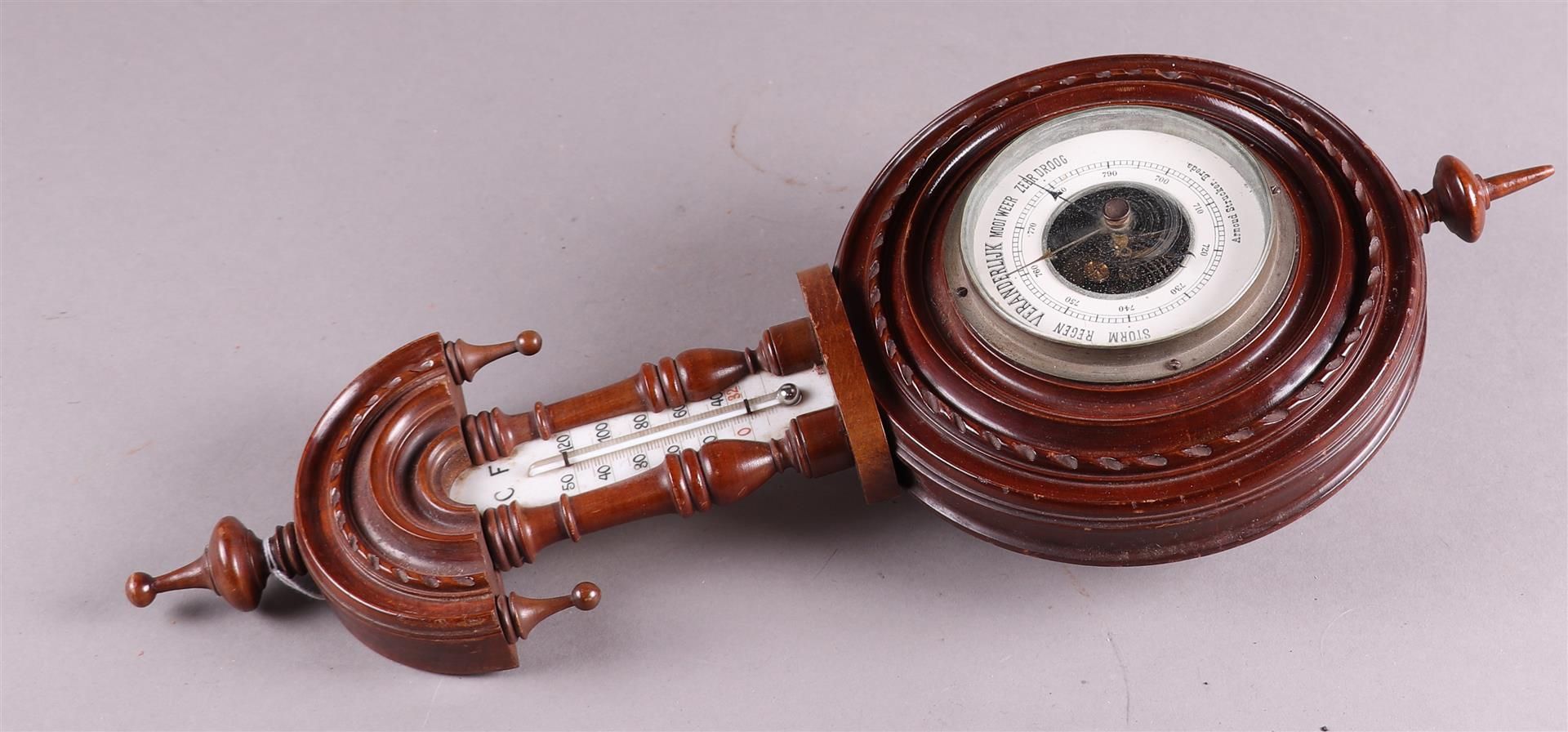 A 1930's barometer with temperature indication, address: Arnoud Strucker, Breda, ca. 1920/30.