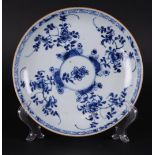 A porcelain deep plate with four blossom branches around a circle in which a small blossom branch