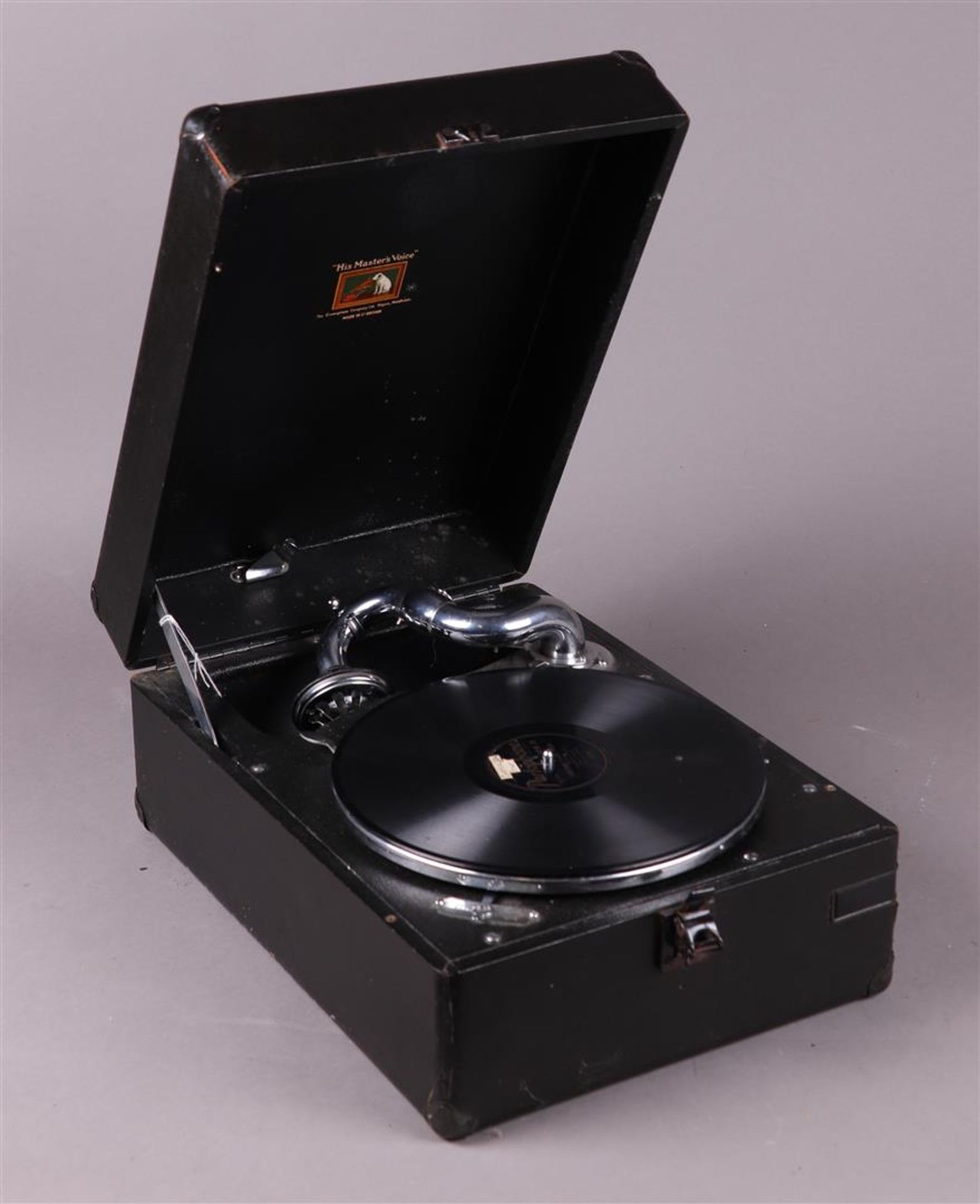 A 'His Master's Voice' suitcase gramophone.