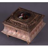 An Art Nouveau, brass jewelery box with enamel plaque of a young woman. about 1880.