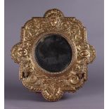 A faceted wall mirror with copper fittings. First half 20th century.