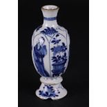 A porcelain vase with knob in the foot, and standing Long Eliza decoration. China, Kanxi.