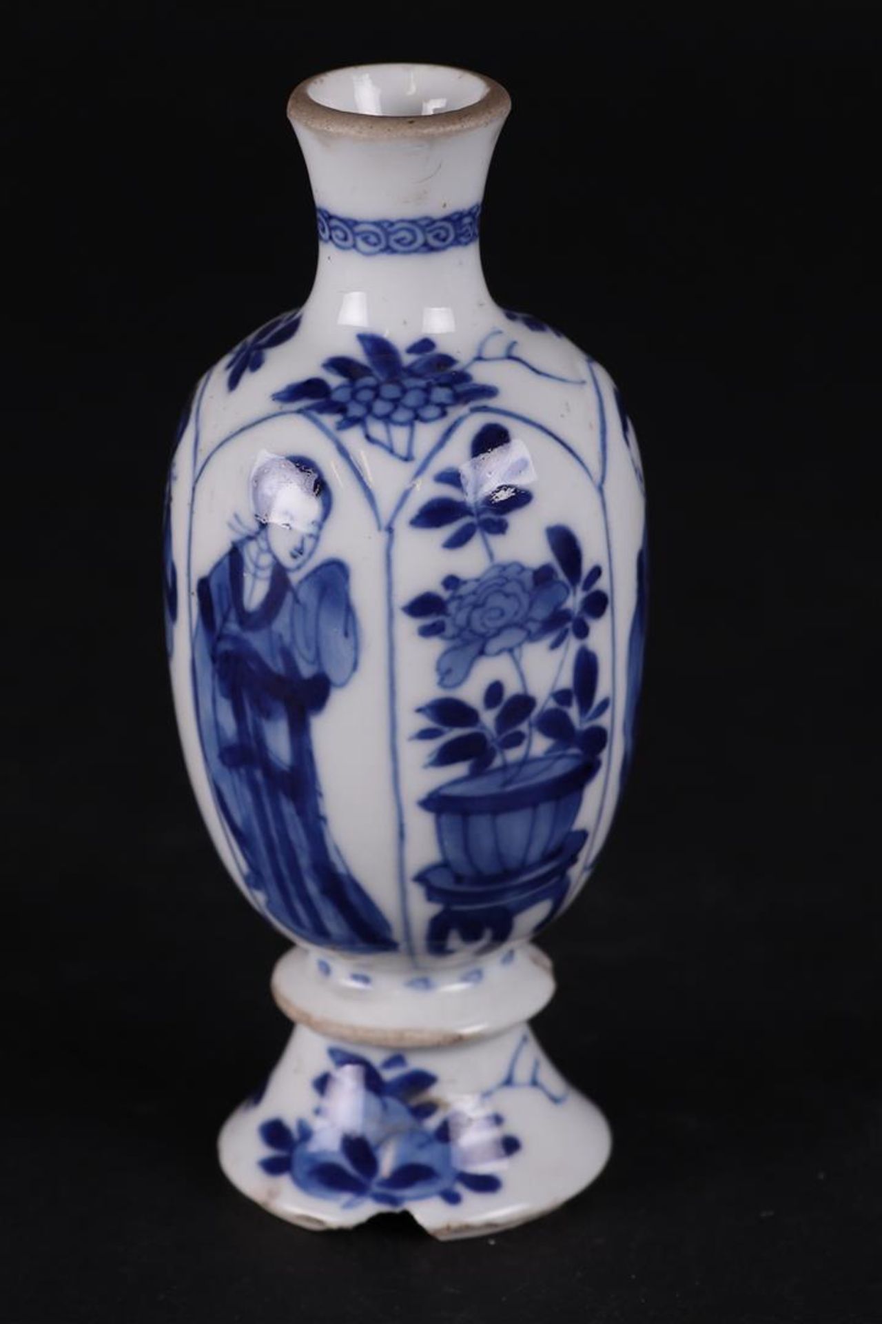 A porcelain vase with knob in the foot, and standing Long Eliza decoration. China, Kanxi. 