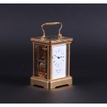 A brass travel clock with enamel dial with Roman numerals and strike on bell. Morrell& Hilton