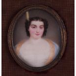 A hand-painted miniature portrait of a young lady. Approx. 1815.